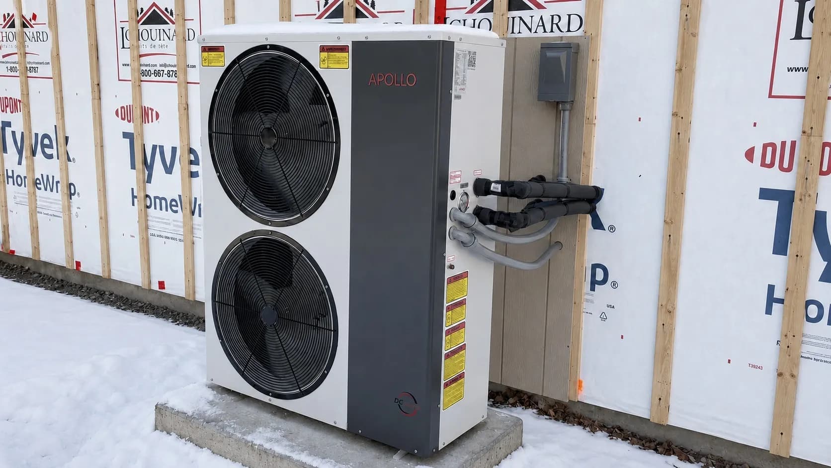 Apollo 5 ton air to water heat pump installed outdoors on a concrete pad in winter conditions.