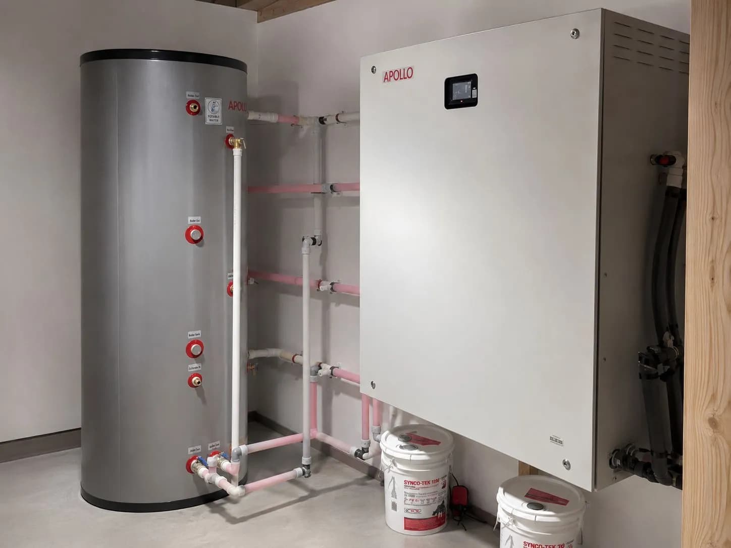 Apollo Hydro Smart station installed beside an Apollo water tank with connected hydronic piping.