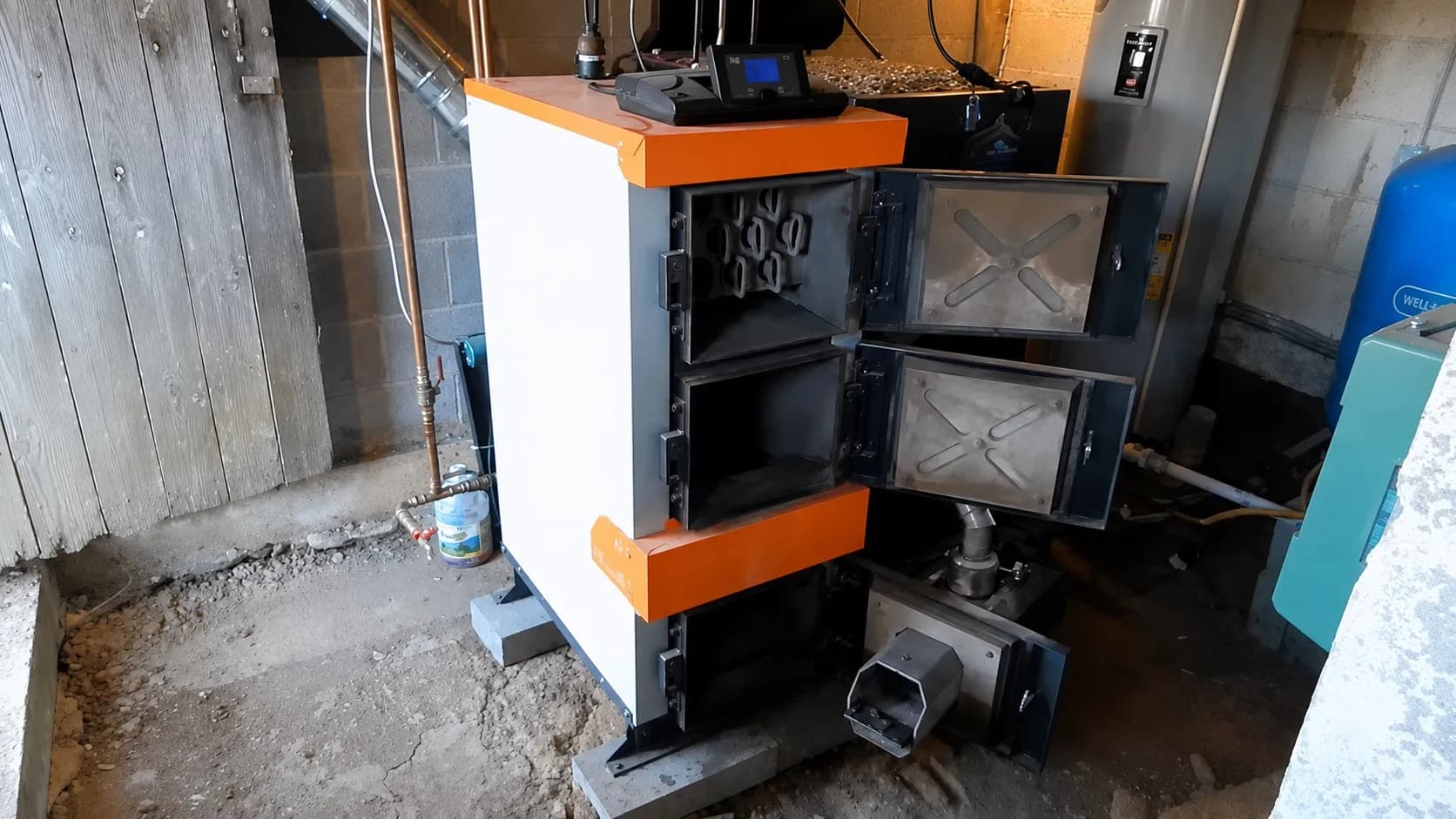 Pellet Duo boiler with its combustion chamber and heat exchanger access doors open.